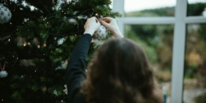 vrouw hangt kerstversiering op